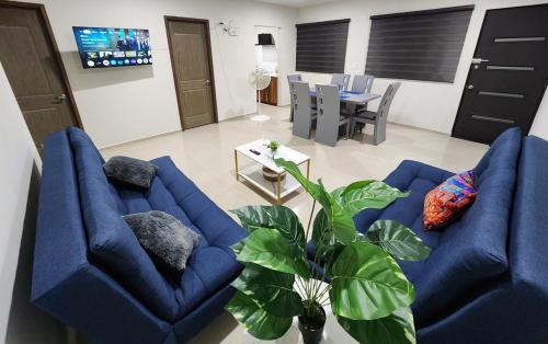 a living room with two blue couches and a table at Downtown Durango, Ground Floor, Spacious and Comfortable Apartment in Durango