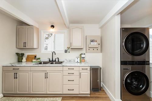 a kitchen with a sink and a washer and dryer at Modern 3BR Getaway-Stylish Ames in Ames