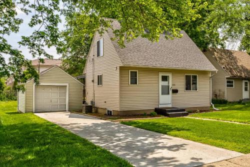 a house with a garage and a driveway at Modern 3BR Getaway-Stylish Ames in Ames