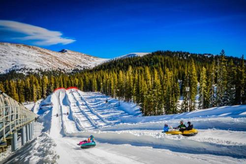 a group of people riding down a snow covered ski slope at Silvermill Lodge 8285 in Keystone
