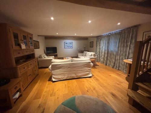a large living room with a couch and a tv at Welsh Apple Barn in Chepstow
