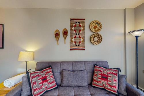 a living room with a couch and plates on the wall at Silvermill Lodge 8202 in Keystone
