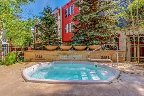 a hot tub in front of a building with trees at Silvermill Lodge 8202 in Keystone