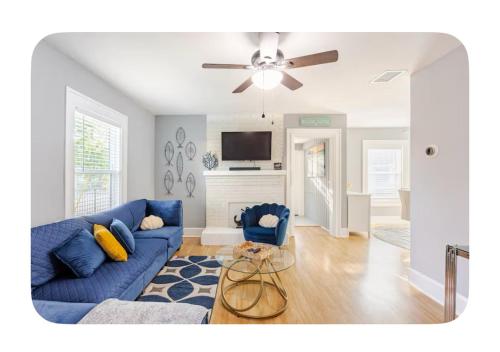 a living room with a blue couch and a ceiling fan at Gated single family home downtown ST Petersburg, FL in St. Petersburg