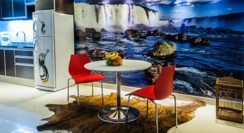 a kitchen with a table and chairs and a waterfall mural at Shoshana Hotel Boutique in Buenos Aires