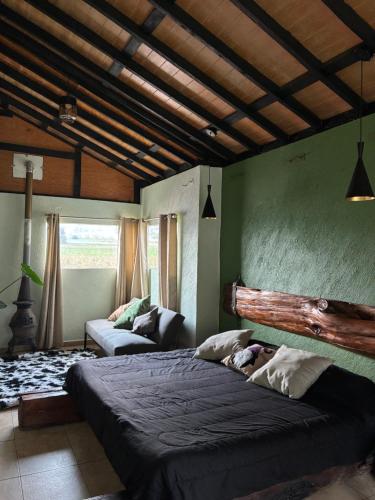 a bedroom with a large bed and a couch at Centro Holístico Kinam in Amecameca de Juárez