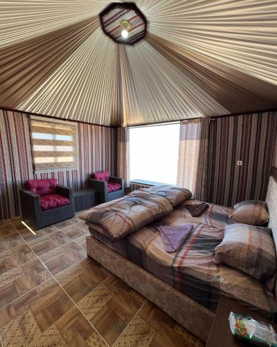 a bedroom with a large bed in a tent at Rum ahmad in Wadi Rum