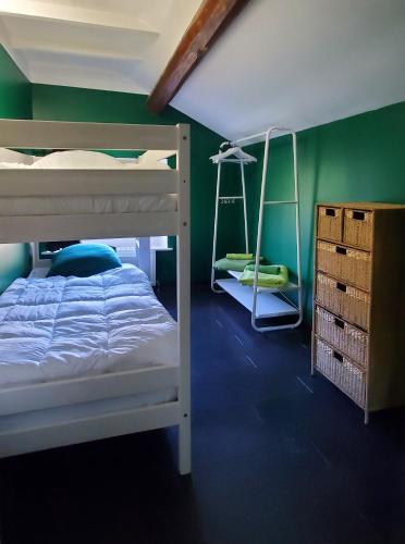 a bedroom with a bunk bed and a green wall at Gite 3 étoiles Escapade à la campagne in Xertigny