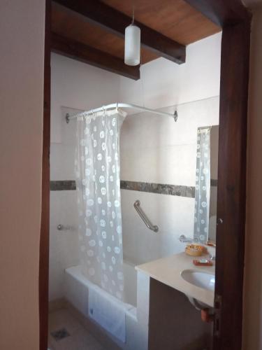 a bathroom with a sink and a bath tub at cabañas Yamasu Huasi in Cafayate