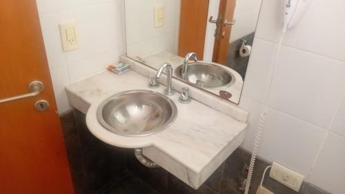 a bathroom with a toilet and a sink at Colina Garden departamento in Victoria
