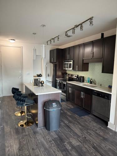 a kitchen with wooden cabinets and a counter with a sink at Dallas Loft-Your getaway home in Dallas