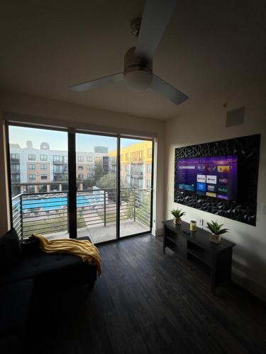 a living room with a couch and a large window at Dallas Loft-Your getaway home in Dallas