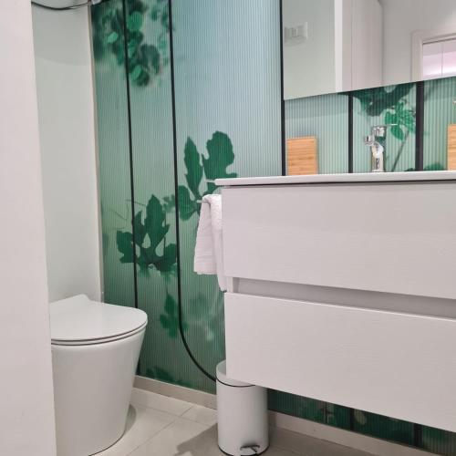 a bathroom with a toilet and a sink and a mirror at RESIDENZA CORSO DALMAZIA in Civitanova Marche