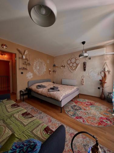 a bedroom with a bed and a rug at CozyHomes in Bansko