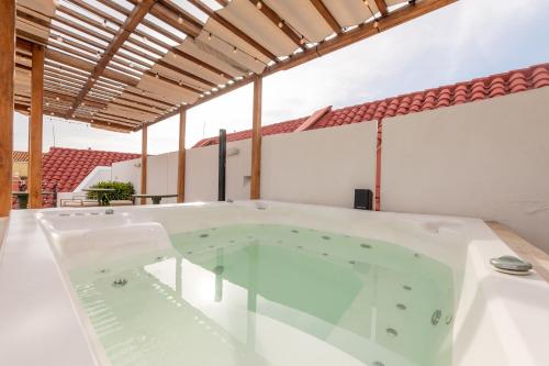 a jacuzzi tub in the middle of a room at Hotel Boutique Bovedas de Santa Clara By Accor in Cartagena de Indias