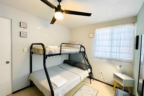 a bedroom with two bunk beds and a ceiling fan at Exclusive Place 10PX 8 Beds Wi-Fi Parking in Reynosa