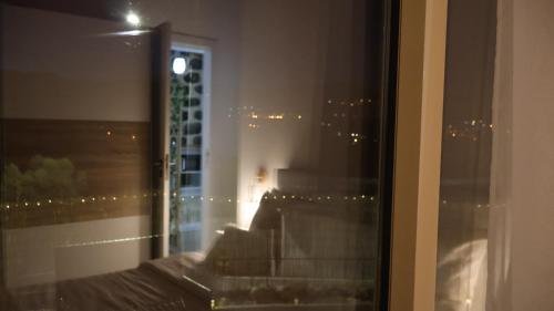 a room with a window with a view of a city at Estadia dos Sonhos in Sequeiros