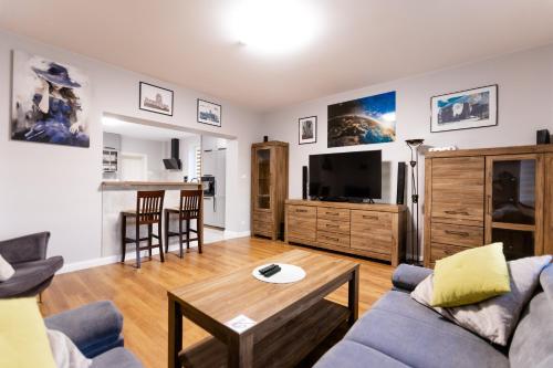 a living room with a couch and a table at Apartament nr 1 Chorzelów in Mielec