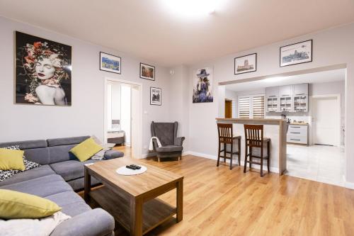 a living room with a couch and a table at Apartament nr 1 Chorzelów in Mielec