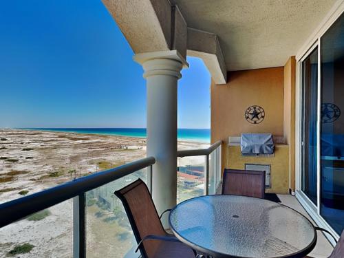 a balcony with a table and chairs and the ocean at Portofino Island Resort #2-1002 in Pensacola Beach