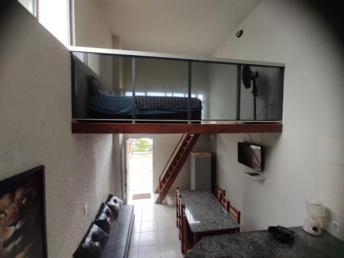 a room with a bunk bed and a staircase at Apto de frente pro mar - 10 min da praia do morro - 08 in Guarapari