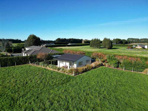 an aerial view of a house in a field at Glenwood Cottage in Kennington