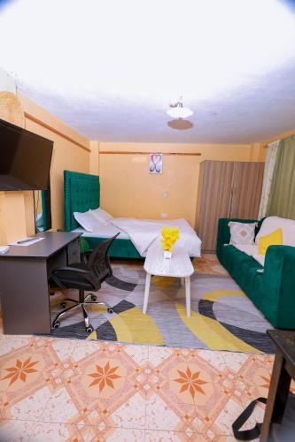 a living room with a desk and a couch at Monett Bay in Wajir