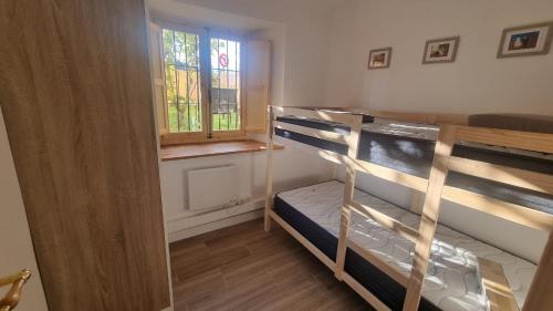 a room with two bunk beds and a window at Llivia 1876 in Llivia