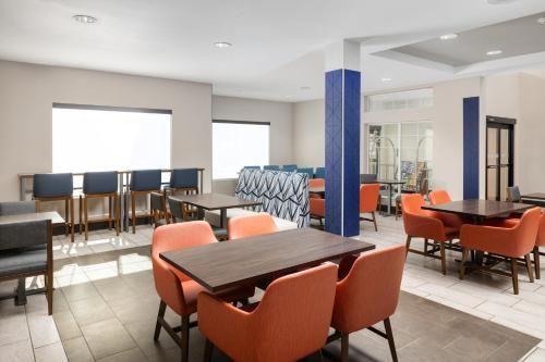 a dining room with tables and chairs at Holiday Inn Express Hotel & Suites North Sequim by IHG in Sequim