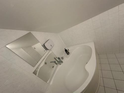 a white bathroom with a toilet and a sink at B&M Studio self-check in in Vilnius