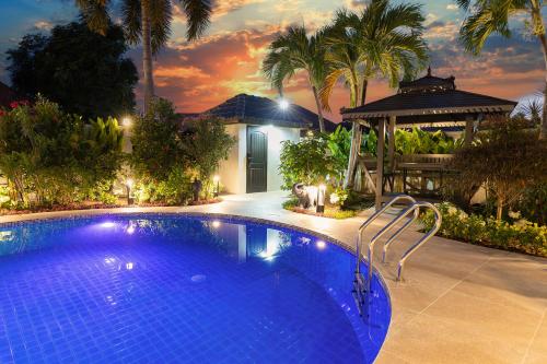 a large blue swimming pool in front of a house at Pattaya Hill minutes from the beach and City Pattaya in Nong Prue