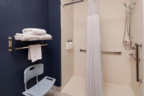 a bathroom with a shower and white towels at Fairfield Inn & Suites Austin University Area in Austin
