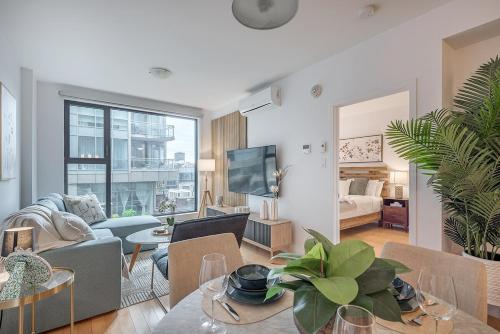 a living room with a couch and a table at Old Port Upscale - Free Indoor Parking in Montréal