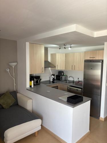 a kitchen with a stainless steel refrigerator and cabinets at Condado de Alhama- Casa Colby in El Romero