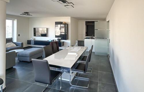 a kitchen and living room with a table and chairs at Luxurious Apartment In Oostende With Wifi in Ostend