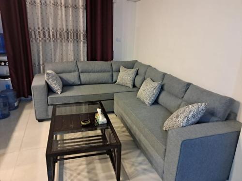 a living room with a couch and a coffee table at طبربور in Amman