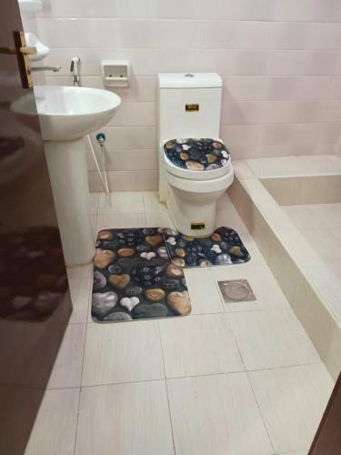 a bathroom with a toilet and a sink at Luxury 2-Bedroom Family Apartment on Buhaira Corniche in Sharjah