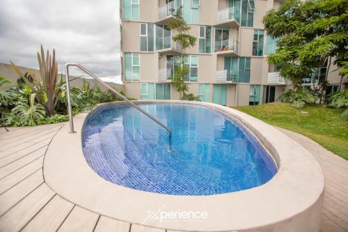 a swimming pool in front of a building at Serenitas at 20, City Views and Wonderland Vibes! in Hatillo