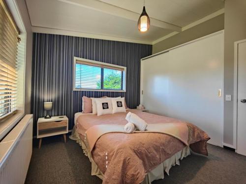 a bedroom with a bed and a window at View Over The Square in Te Anau