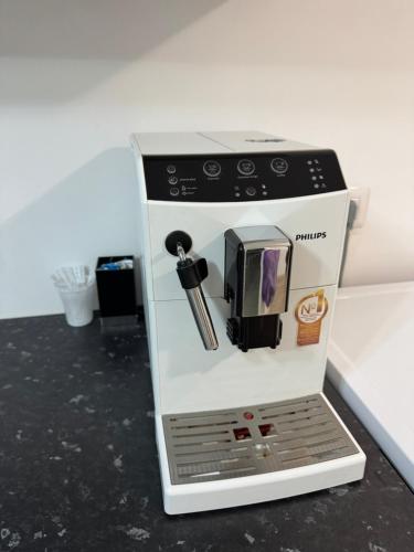 a model of a coffee maker is on a counter at Apartament Brazdă in Craiova