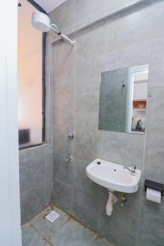 a bathroom with a sink and a mirror at Kiambu cozy studio in Kiambu