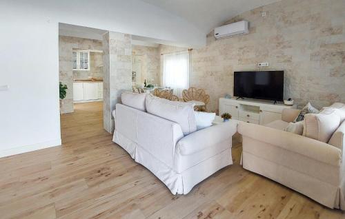 a living room with two white couches and a television at Lovely Home In San Antoniojerez De L With Wifi in La Barca de la Florida