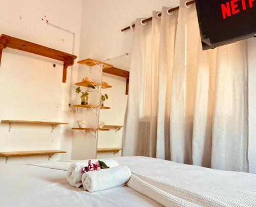 a bedroom with a bed with a towel on it at Casa Baly Jericoacoara in Jericoacoara