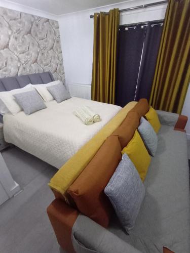 a hotel room with a bed and a couch at Bavelle Bilston Urban Village in Bilston