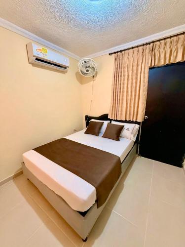 a bedroom with a large bed in a room at Hotel Buenavista Valledupar in Valledupar