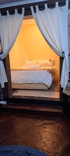 a bedroom with a bed with a canopy at Diani's Little Gem in Ukunda