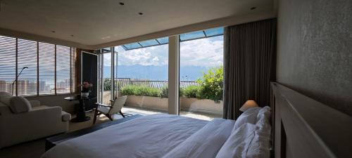 a bedroom with a bed and a large window at Tree House Dali 清朴小院 大理 in Dali Airport