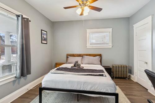 a bedroom with a bed and a ceiling fan at BrewLoft Cleveland - Near Rock Hall & Downtown in Lakewood