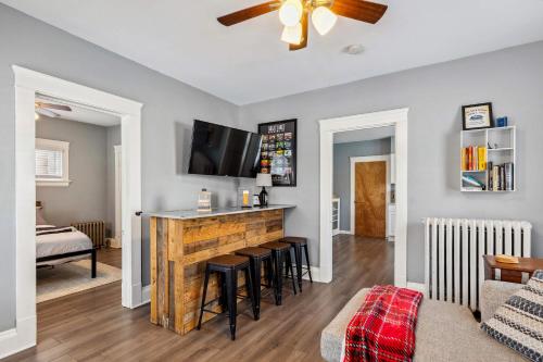 a living room with a bar with stools at BrewLoft Cleveland - Near Rock Hall & Downtown in Lakewood