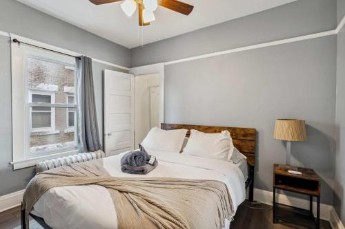 a bedroom with a bed with a hat on it at BrewLoft Cleveland - Near Rock Hall & Downtown in Lakewood